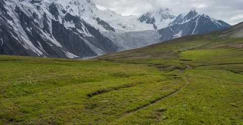 Trekking trail in Patundas trekking route with Passu glacier in background, Karakoram mountains range